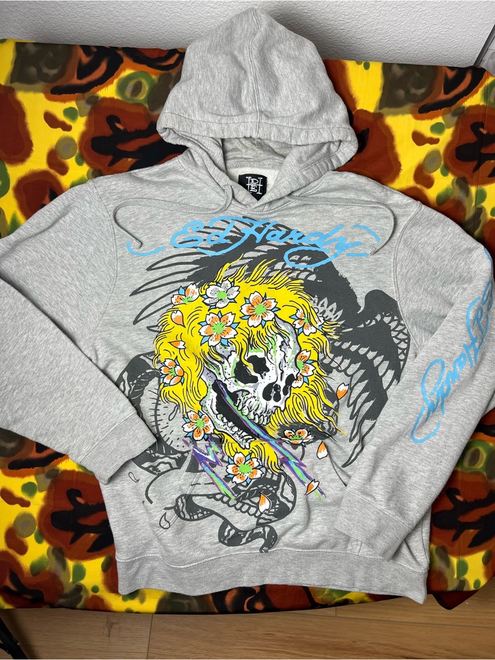 Ed Hardy gray hoodie with yellow skull with flowers and blue graffiti-style text